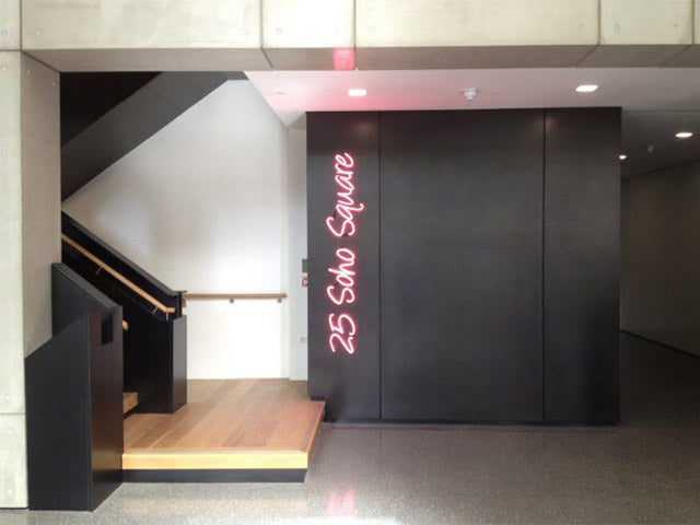 25 Soho Square' pink neon sign. Real glass neon fitted directly onto the wall.