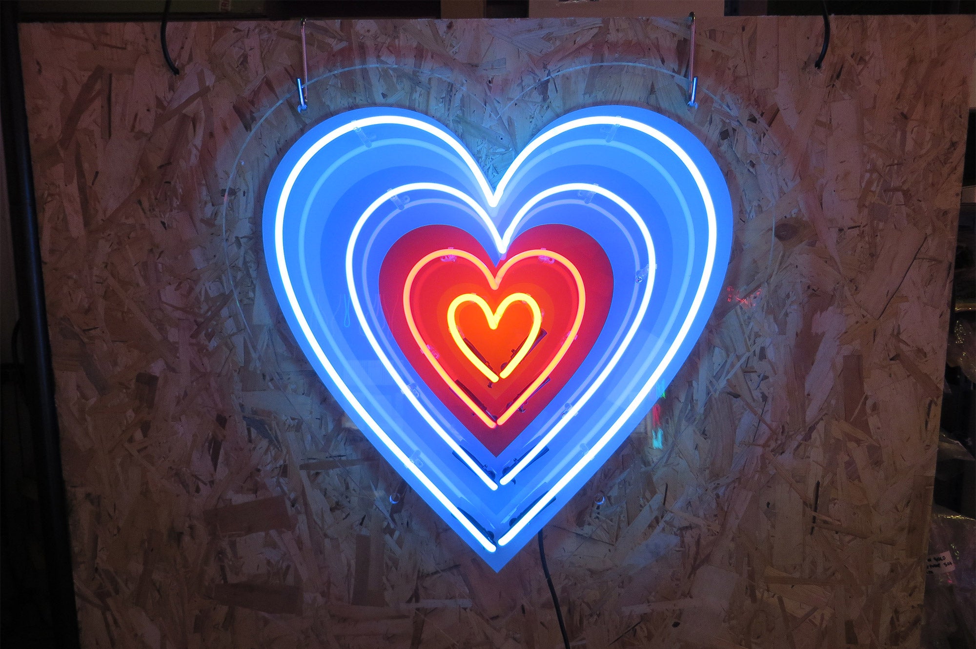 4 hearts' multi-coloured neon sign. Real glass neon fitted onto clear acrylic panel cut to shape.