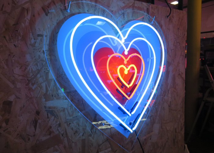 4 hearts' multi-coloured neon sign. Real glass neon fitted onto clear acrylic panel cut to shape.