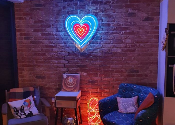 4 hearts' multi-coloured neon sign. Real glass neon fitted onto clear acrylic panel cut to shape.