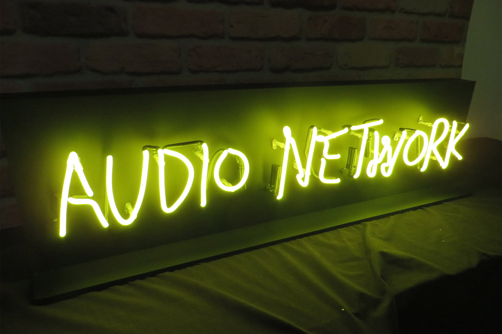 Audio Network' yellow LED sign. NeonPlus LED fitted into clear acrlyic case.