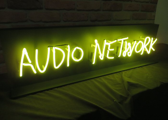 Audio Network' yellow LED sign. NeonPlus LED fitted into clear acrlyic case.