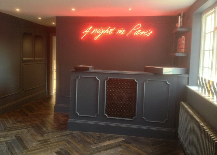 A night in Paris' red neon sign. Real glass neon fitted directly onto wall.