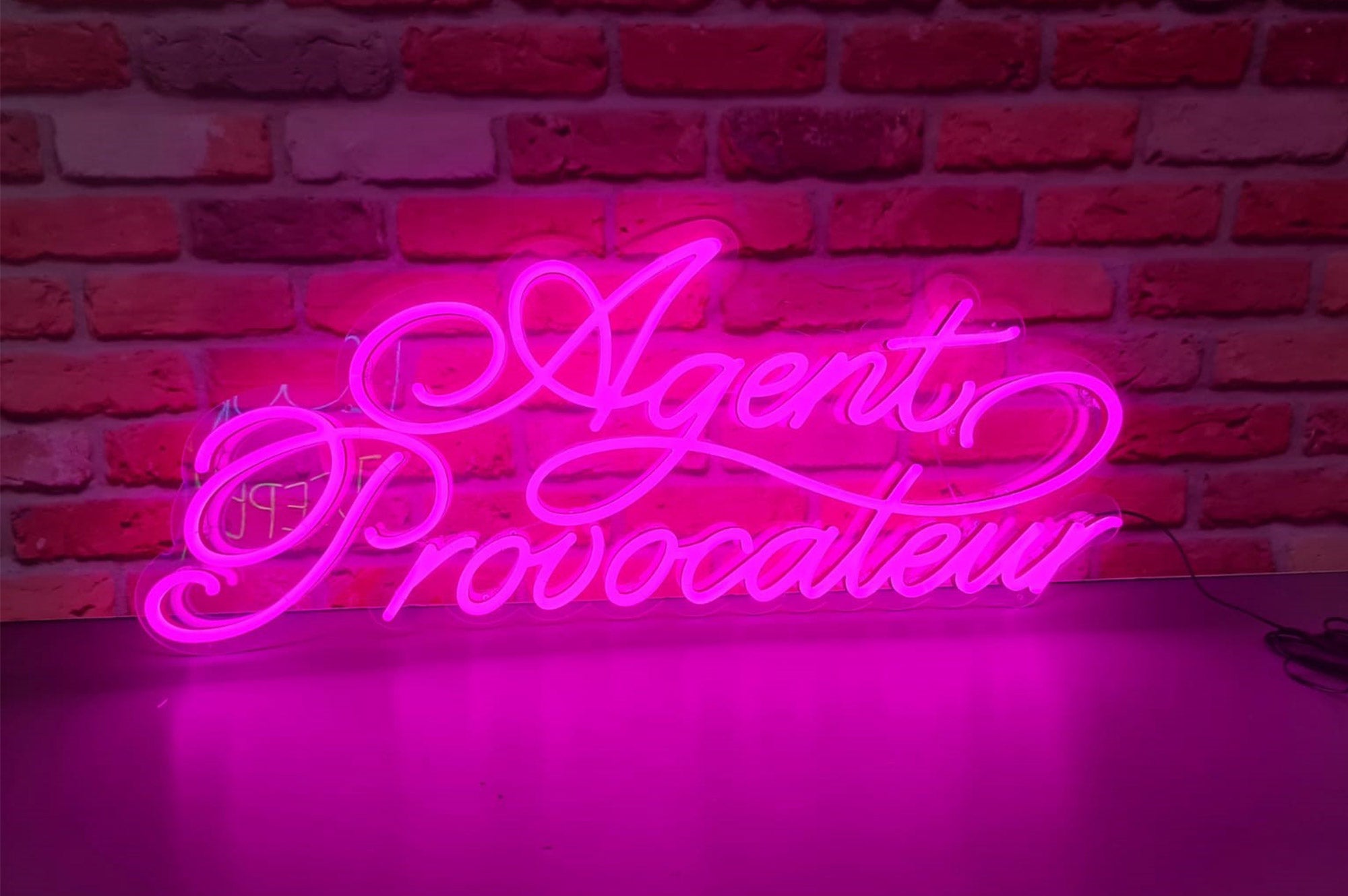 Agent Provocateur' pink LED sign. NeonPlus LED fitted onto cut to shape clear panel.