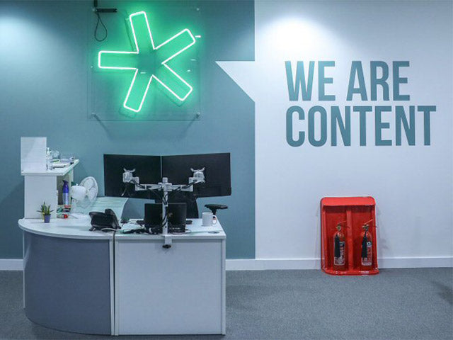 Asterisk' green neon sign. Real glass neon on a clear acrylic panel.