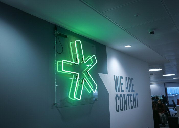 Asterisk' green neon sign. Real glass neon on a clear acrylic panel.