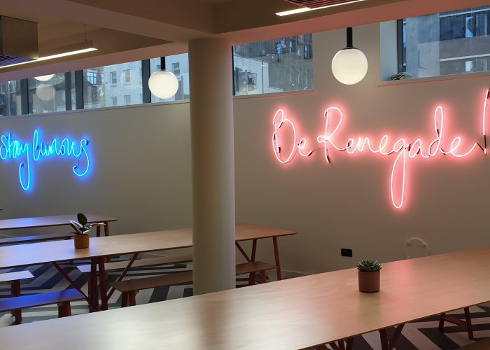 Be Renegade!' pink neon sign. Real glass neon fitted directly onto the wall.