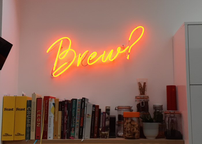 Brew?' orange neon sign. Real glass neon fitted directly onto wall.