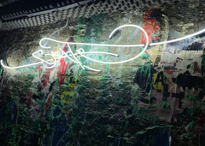 Create' white neon sign. Real glass neon fitted directly onto wall.