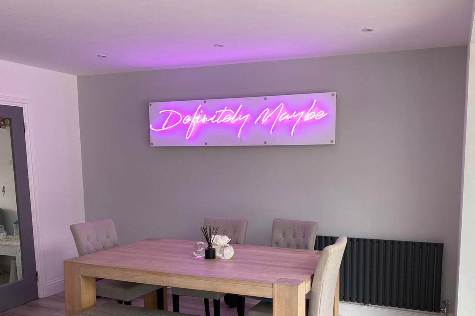 Definitely Maybe' purple neon sign. Real glass neon on a satin white acrylic panel.