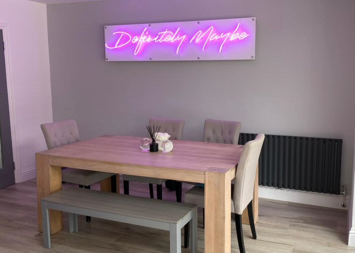 Definitely Maybe' purple neon sign. Real glass neon on a satin white acrylic panel.