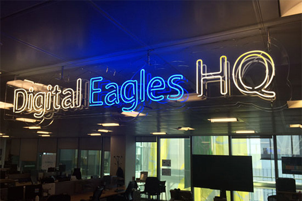 Digital Eagles HQ' white and blue neon sign. Real glass neon on a clear acrylic panel cut to shape.