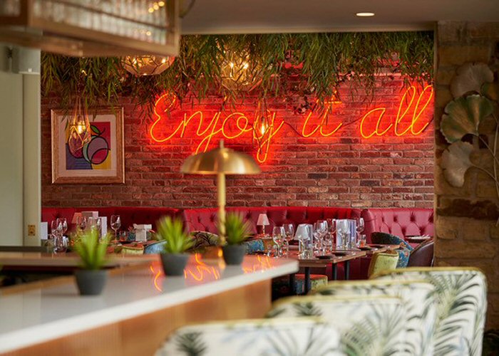 Enjoy it all' red neon sign. Real glass neon fitted directly onto wall.