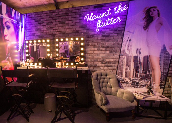 Flaunt the flutter' purple neon sign. Real glass neon mounted on clear acrylic panel.