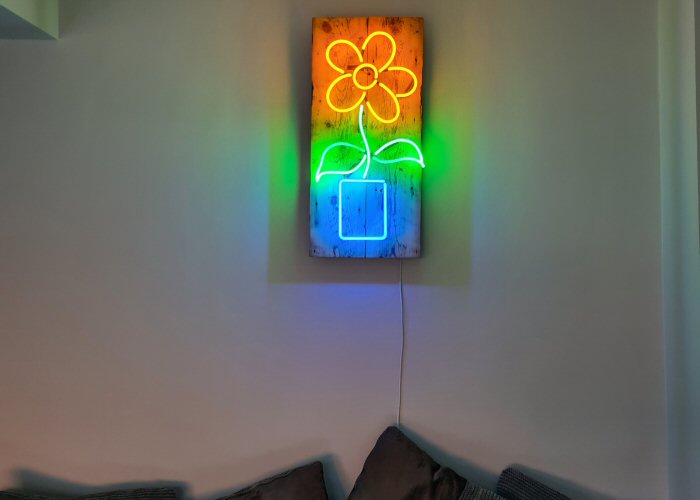 Flower' multi-coloured neon sign. Real glass neon mounted on to reclaimed wooden panel.