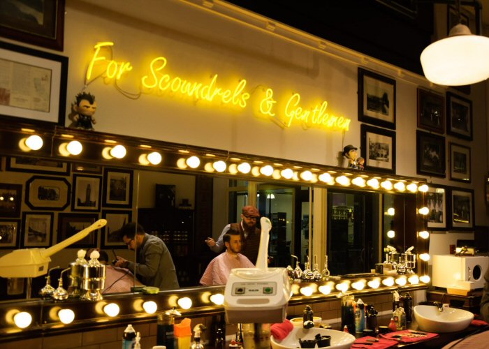 For Scoundrels & Gentlemen' yellow neon sign. Real glass neon fitted directly onto the wall.