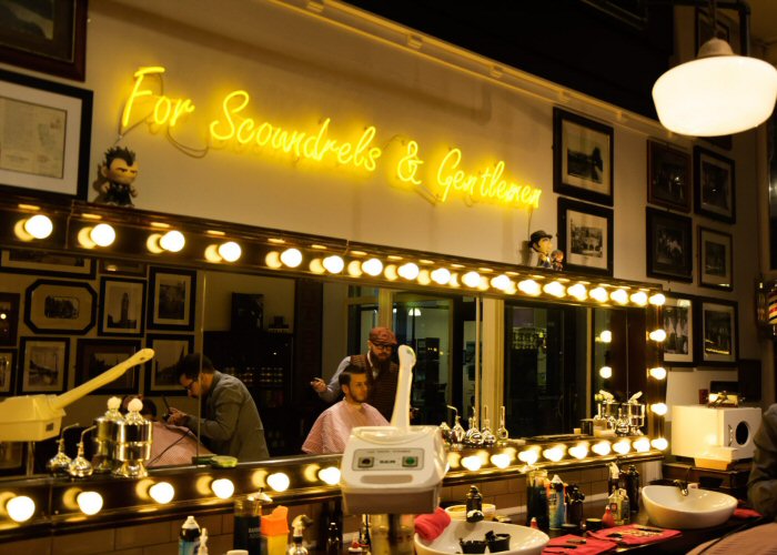 For Scoundrels & Gentlemen' yellow neon sign. Real glass neon fitted directly onto the wall.