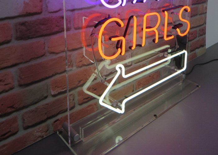 GIRLS GIRLS GIRLS' neon sign for home. Real glass neon on a free standing clear acrylic panel.