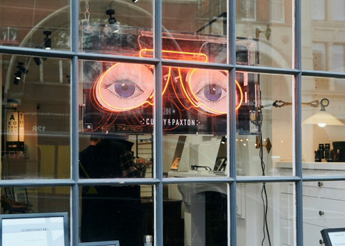 Glasses' red neon sign. Real glass neon fitted inside acrylic case with printed back.