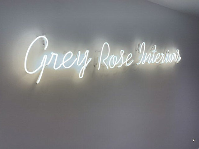Grey Rose Interiors' white neon sign. Real glass neon fitted directly onto the wall.