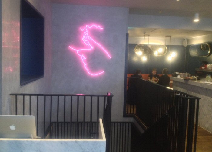 Kissing couple' red neon artwork. Real glass neon fitted directly onto wall.