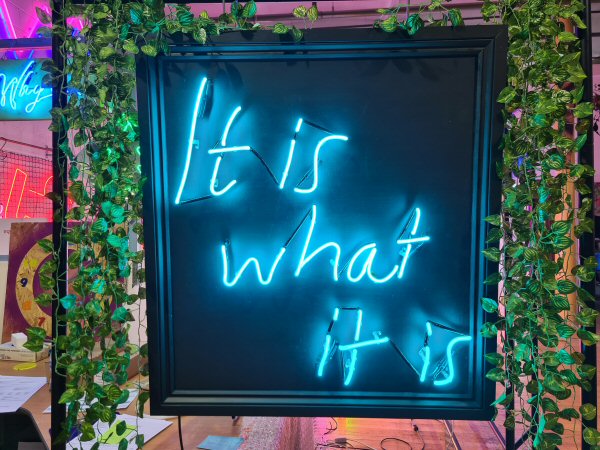 It is what it is' turquoise neon sign. Real glass neon on a painted and framed MDF panel.