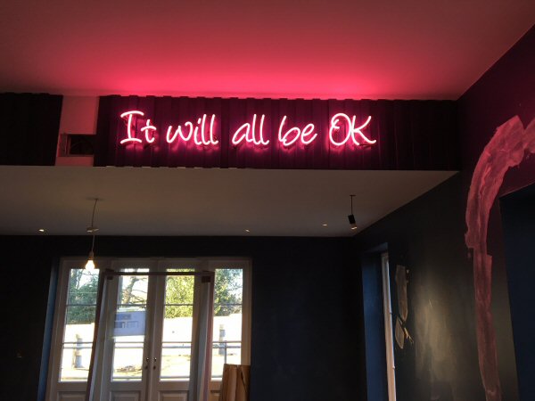 It will all be OK' pink neon sign. Real glass neon fitted directly onto wall.
