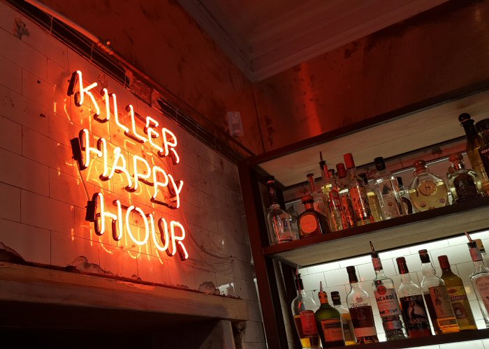 KILLER HAPPY HOUR' red neon sign. Real glass neon fitted directly onto wall.