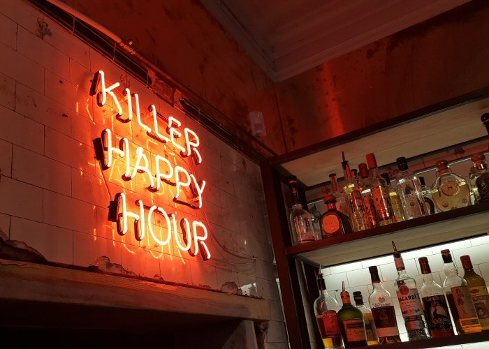 KILLER HAPPY HOUR' red neon sign. Real glass neon fitted directly onto wall.