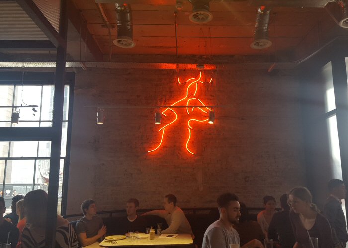 Kissing couple' red neon artwork. Real glass neon fitted directly onto wall.