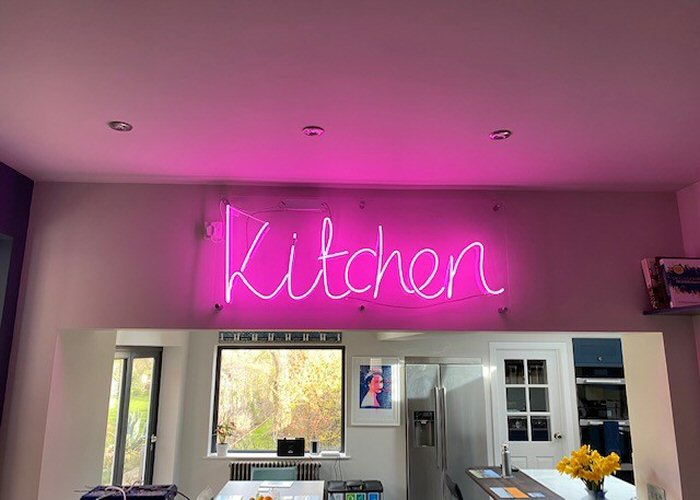 Kitchen' pink neon sign. Real glass neon mounted on clear acrylic panel.