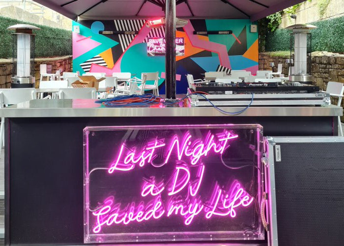 Last Night a DJ Saved my Life' pink neon sign. Real glass neon fitted inside clear acrylic case.