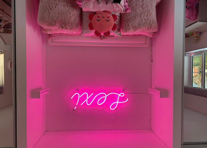 Lexi' pink neon sign. Real glass neon mounted onto a clear acrylic panel cut to shape.
