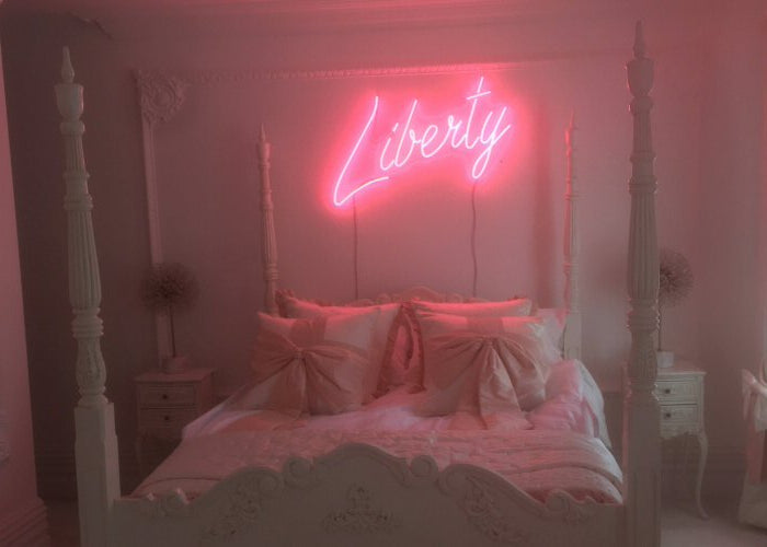 Liberty' pink neon sign. Real glass neon mounted directly onto wall.