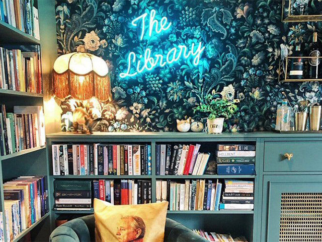 The Library' turquoise neon sign. Real glass neon mounted directly onto wall.