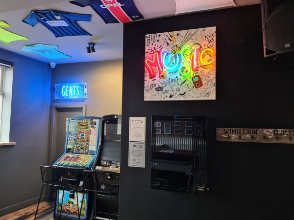 MUSIC' multi-coloured neon light. Real glass neon fitted onto white acrylic case with printed face.