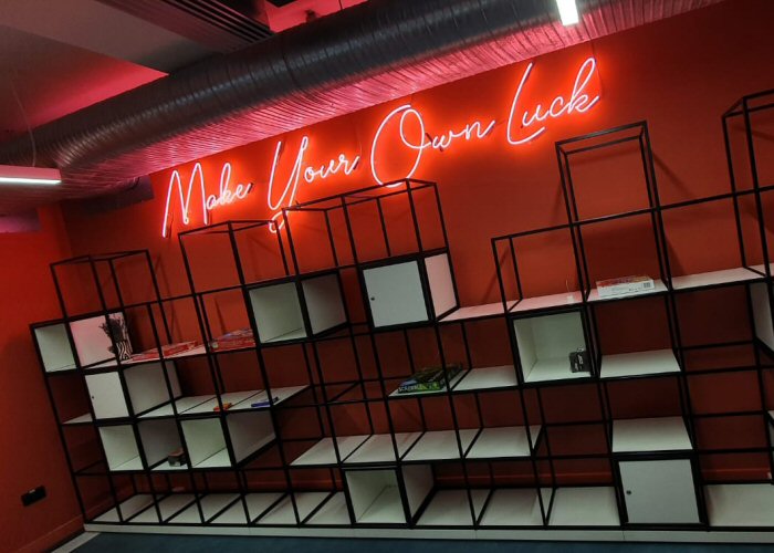 Make Your Own Luck' pink neon sign. Real glass neon fitted directly onto the wall.