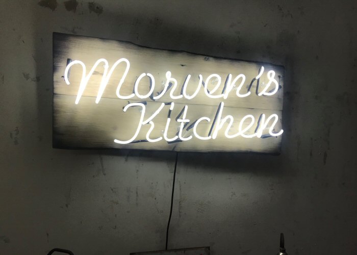 Morven's Kitchen' white neon sign. Real glass neon mounted on to reclaimed wooden panel.