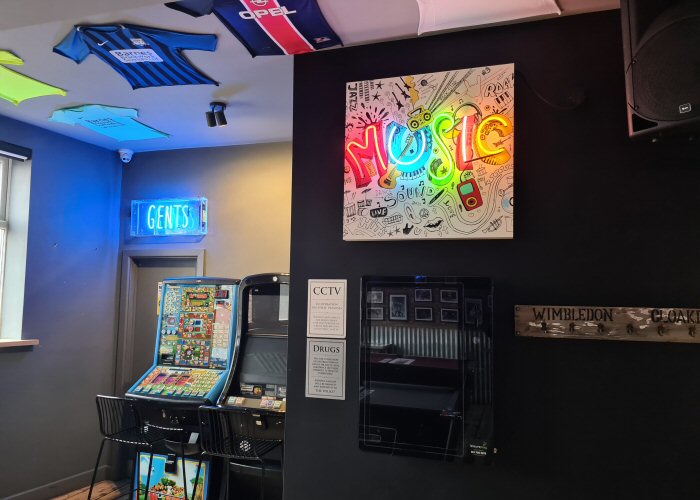 MUSIC' multi-coloured neon light. Real glass neon fitted onto white acrylic case with printed face.