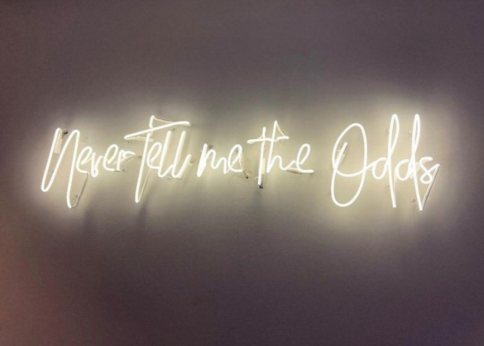 Never Tell me the Odds' white neon sign. Real glass neon fitted directly onto wall.