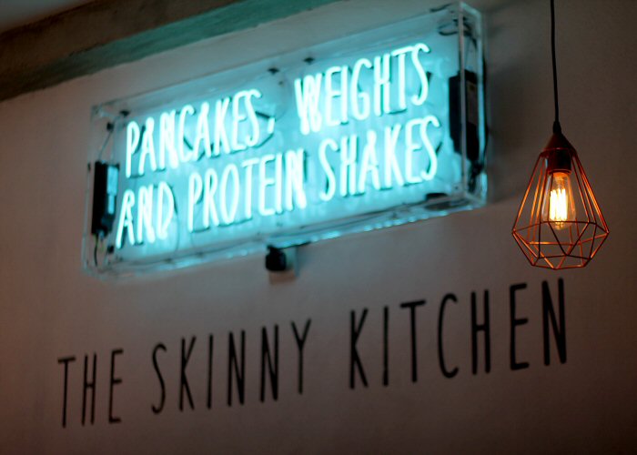 Pancakes, Weights and Protein Shakes' turquoise neon sign. Real glass neon fitted inside clear acrylic case.