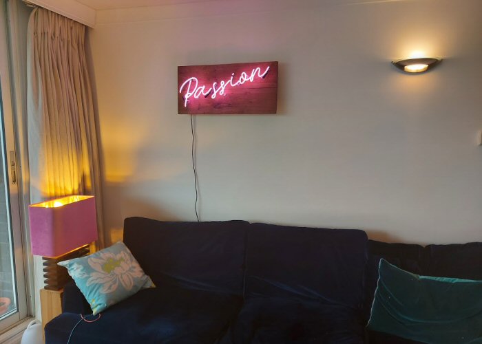 Passion' pink neon sign. Real glass neon mounted on to reclaimed wooden panel.