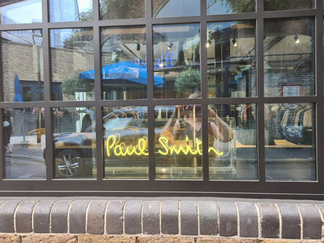 Paul Smith' white neon sign. Real glass neon fitted inside clear acrylic case.