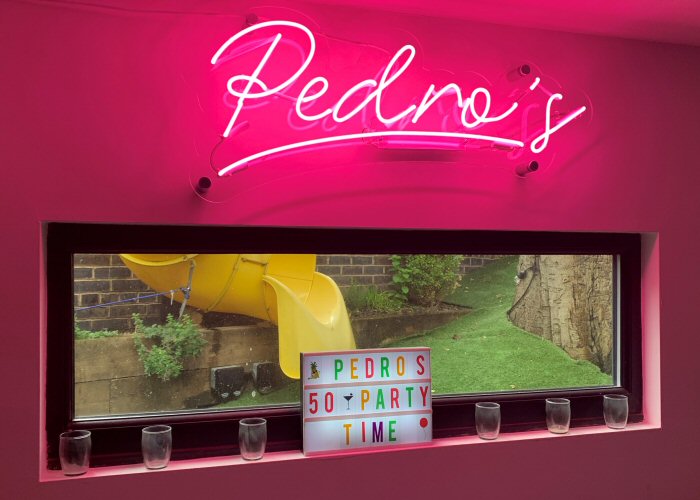 Pedro's' pink neon bar sign. Real glass neon on a clear acrylic panel cut to shape.
