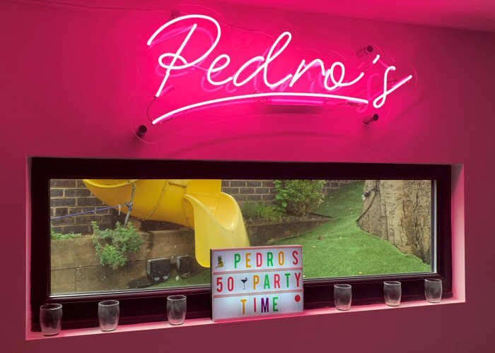 Pedro's' pink neon bar sign. Real glass neon on a clear acrylic panel cut to shape.