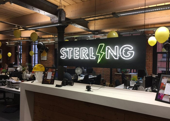 STERLING' white and yellow neon sign. Real glass neon fitted onto a black acrylic panel.