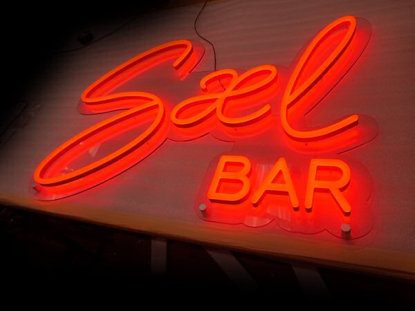 Sael Bar' red LED sign. NeonPlus LED fitted onto cut to shape clear panel.