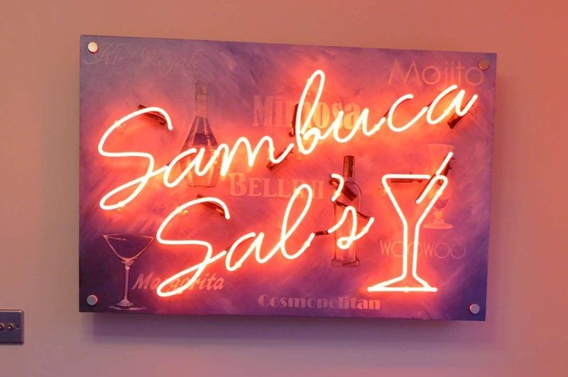 Sambuca Sal's red neon light. Real glass neon fitted onto backing panel supplied by client.