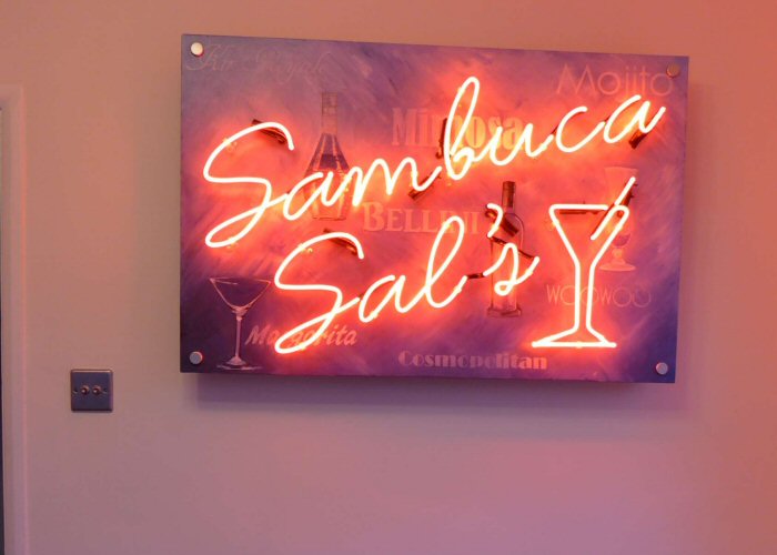 Sambuca Sal's red neon light. Real glass neon fitted onto backing panel supplied by client.