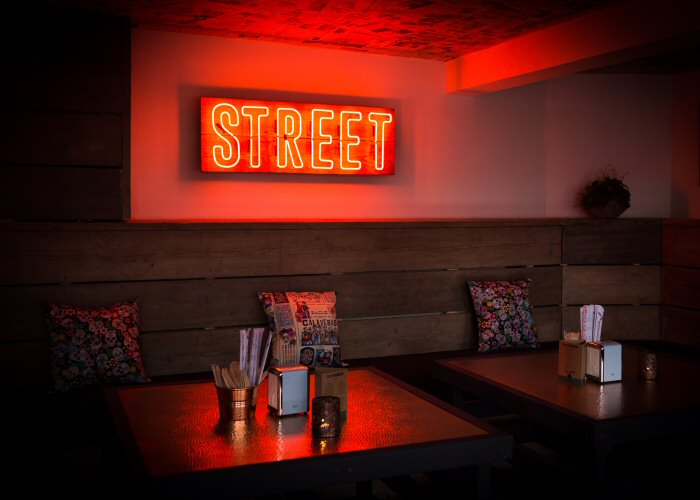 STREET' amber neon sign. Real glass neon fitted onto reclaimed wooden panel.